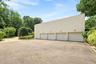 Expansive four-car garage with ample parking within the beautifully landscaped grounds.