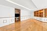 Landing area with built-in bookshelves and flat screen TV on second floor