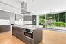 Kitchen island includes stove top and oven.