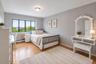 Hardwood-finish flooring and light gray walls create a neutral palette