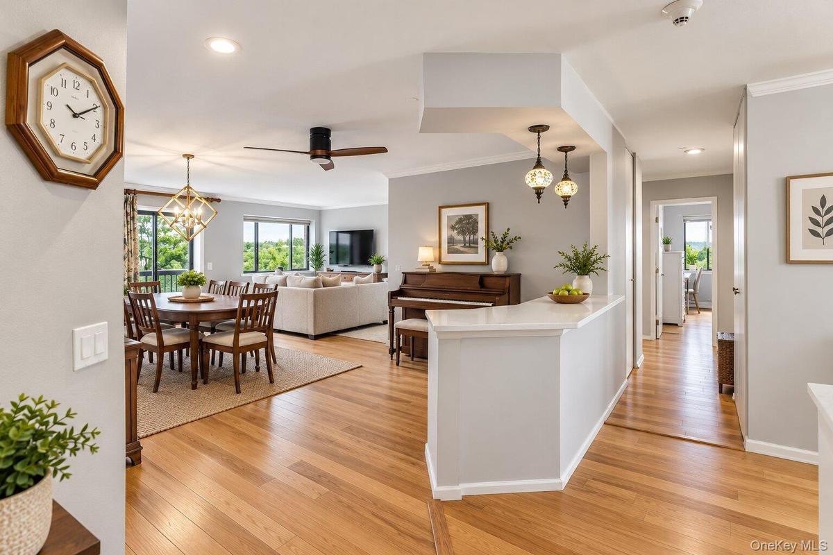 Hardwood flooring, recessed lighting, and crown molding