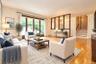 Photo Visually Staged.   Living Room has a bay window, hardwood floors and opens to the dining room. Living room is approx 16'-6" x 14'-11"