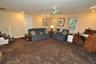 Lower Level recreation room has a fireplace, access to the outside, garage and utility room and storage.  The room is approx. 19'-4" x 18'-6".
