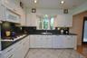 Updated Eat-in-kitchen with granite counters, Stainless Steel French Door refrigerator, wall oven, stove top, and microwave.  There is a window over t