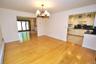 Photo Visually Staged.  The Dining Room has hardwood floors, opens to both the Kitchen and Living room and has sliding glass doors to the back patio a