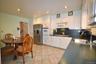 Updated Eat-in-kitchen with granite counters, Stainless Steel French Door refrigerator, wall oven, stove top, and microwave.  There is a window over t