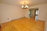 Photo Visually Staged.  The Dining Room has hardwood floors, opens to both the Kitchen and Living room and has sliding glass doors to the back patio a