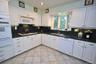 Updated Eat-in-kitchen with granite counters, Stainless Steel French Door refrigerator, wall oven, stove top, and microwave.  There is a window over t