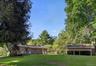 Flat Backyard with Ride-In Barn Behind Main Home