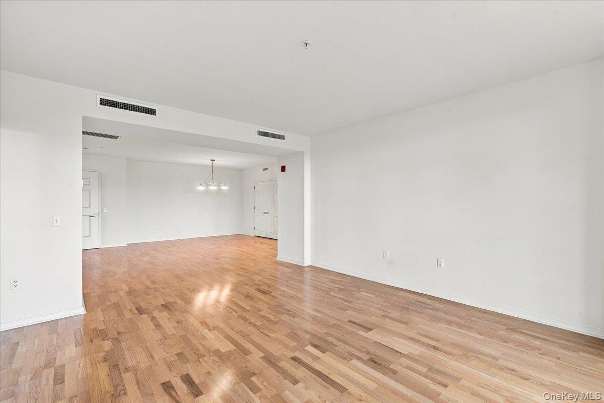 Open-concept interior featuring wood flooring and white walls