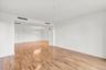 Open-concept interior featuring wood flooring and white walls