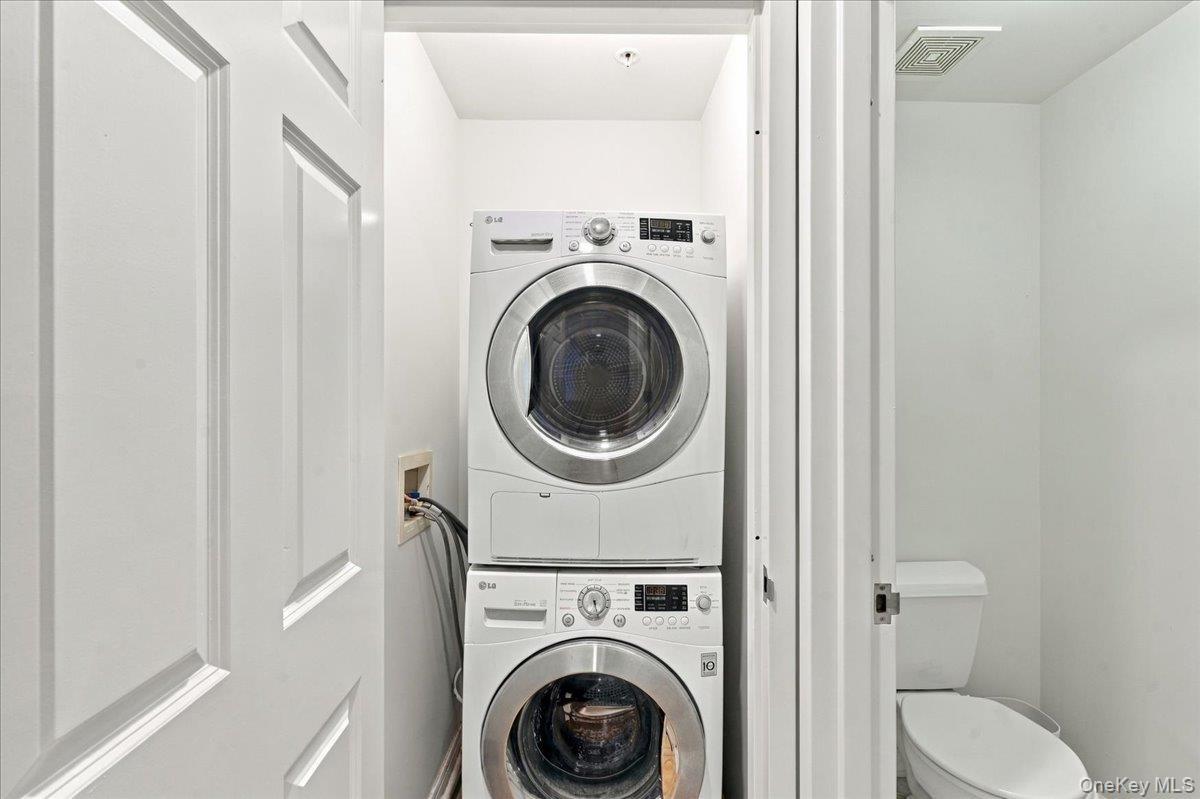 Stackable laundry appliances within a dedicated utility space