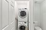 Stackable laundry appliances within a dedicated utility space