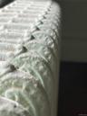 Original ornate cast-iron radiator featuring intricate raised-relief scrollwork, painted yet it made for a cool photograph.