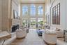 floor to ceiling windows, marble floors + a grand fireplace