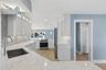 Looking into the kitchen from the small den with fireplace