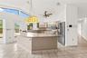Functional kitchen with ample cabinetry and workspace, providing a practical layout with potential for modern updates or redesign to maximize value.