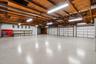 Expansive garage infrastructure featuring two separate buildings with combined 8-car capacity, ideal for collectors or those seeking elevated storage 
