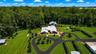 Aerial perspective showcasing the extraordinary scale of the estate's commercial and storage facilities, including multiple high-capacity structures d