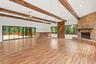Spacious living area filled with natural light, offering a comfortable layout ideal for everyday living or future customization. A welcoming central g