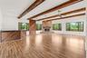 Inviting living space featuring a fireplace framed by a warm wood accent wall and a built-in bar area, creating an ideal setting for relaxing and ente