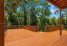 Comfortable exterior deck space offering a quiet retreat with views of the expansive acreage.