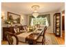 Formal dining space featuring hardwood flooring, wainscoting, and a chandelier with a decorative medallion
