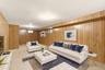 Wood-paneled walls with integrated door, recessed ceiling lighting, and light-toned flooring