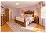 Hardwood flooring, cased window with drapes, cased doorway, flush-mount ceiling light fixture, and decorative wall art