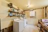Wall-mounted shelving, built-in wall cabinet, and overhead lighting
