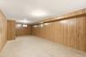 Wood paneling throughout, multiple windows for natural light, and tile flooring