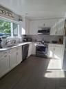 Stainless steel appliances and eat in area and access to living room