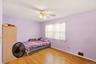 Wood-finish flooring, ceiling fan, and window with blinds