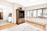 Living area with baseboard heating, healthy amount of natural light, and light wood-type flooring