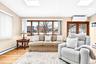 Living room featuring a skylight, light wood-style floors, a wall mounted AC, and recessed lighting