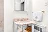 Full bath with a sink and radiator