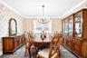 Dining space with healthy amount of natural light, a chandelier, wallpapered walls, and ornamental molding