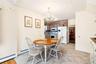 Dining space featuring a baseboard radiator, a chandelier, and light tile patterned floors