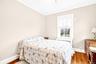 Bedroom featuring ornamental molding, light wood-style floors, radiator, and a ceiling fan