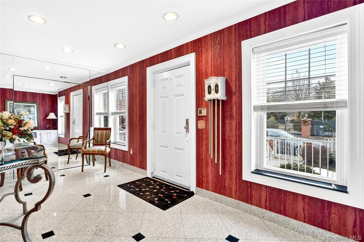 Entryway featuring wooden walls, crown molding, and recessed lighting
