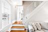 Staircase featuring plenty of natural light and wood finished floors