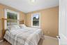 Neutral tone wall paint, white trim windows, and carpet flooring