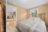 Neutral wall color, carpeted flooring, and white window trim