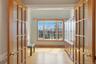 This room features hardwood floors and a large bay window providing abundant natural light