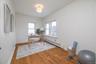 Bedroom with hardwood floors, currently used as an office.