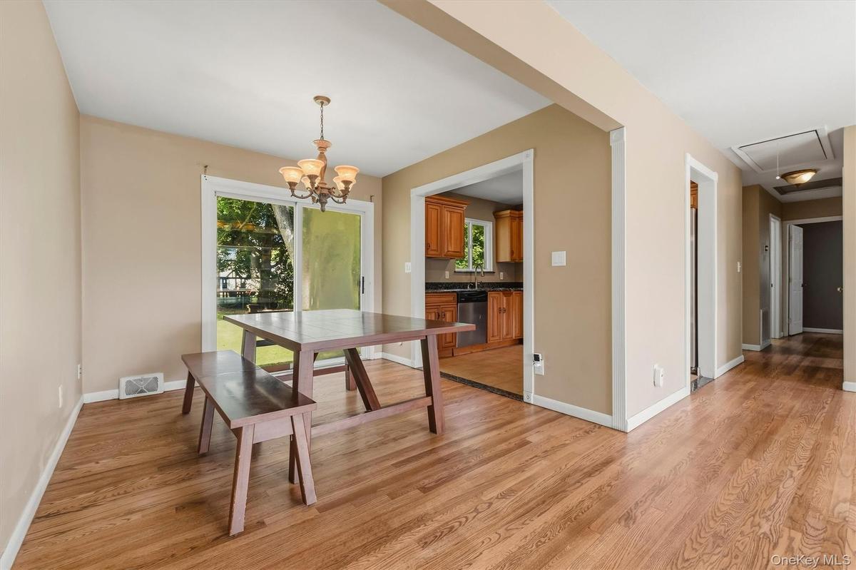 Formal dining room with sliding glass door to patio and yard.