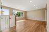 The spacious, sun filled living room features an oversized picture window.
