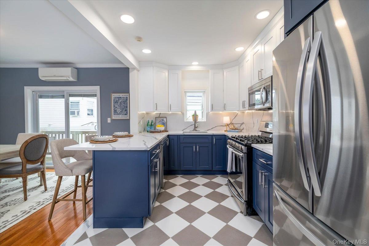 Newly renovated kitchen with stainless steel appliances and gas cooking.