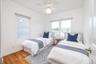 Bedroom with hardwood floors and lots of natural light