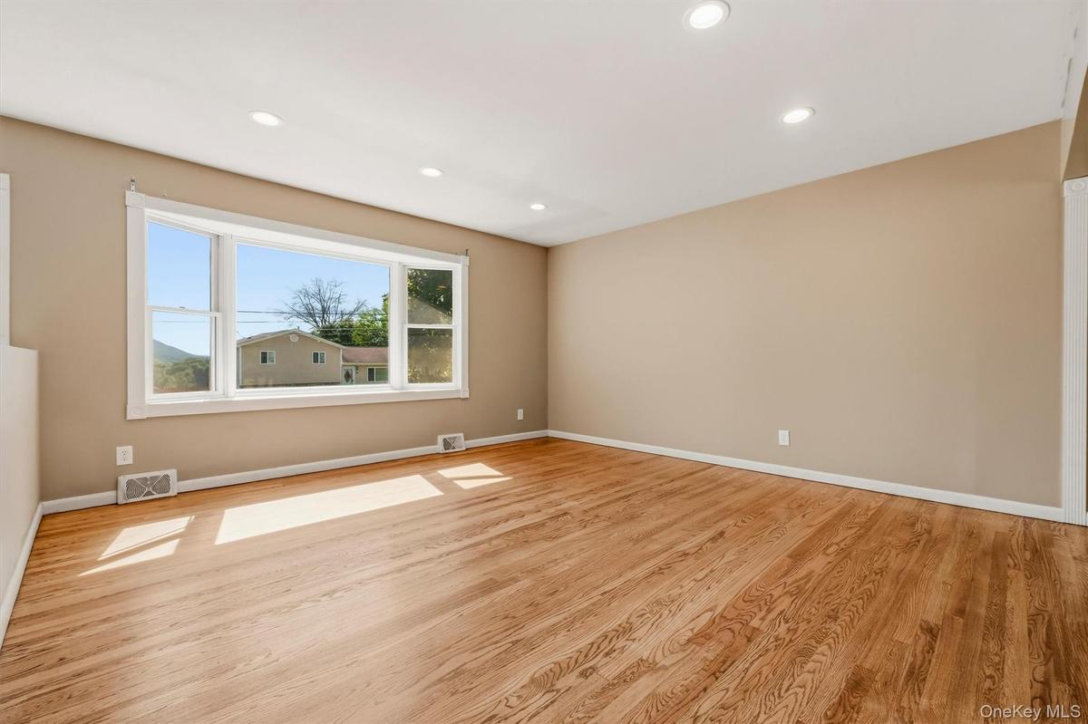 Gleaming, newly refinished hardwood flooring accents the main level.